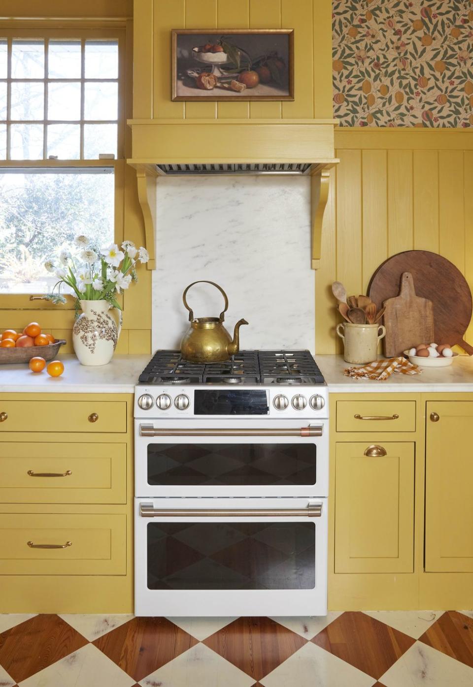 yellow farmhouse kitchen with white gas range
