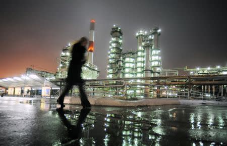 A man walks in front of the Novokuibyshevsk refinery near the city of Samara, October 28, 2010. REUTERS/Nikolay Korchekov/File Photo