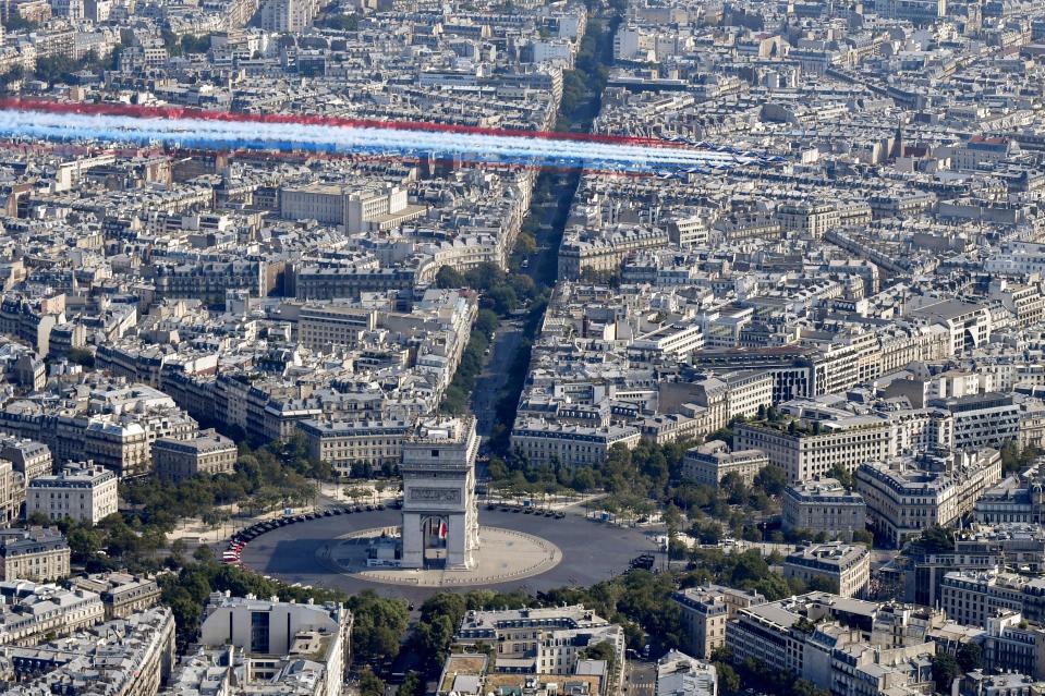 <p>The Patrouille de France Alpha Jet aircrafts fly over the Arc de Triomphe at the start of the annual Bastille Day military parade on the Champs-Élysées in Paris on July 14, 2018. (Photo: Gerard Julien/AFP/Getty Images) </p>