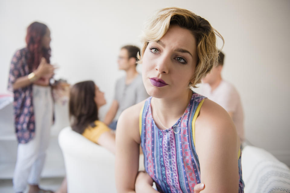 A woman ignoring her friends in the background