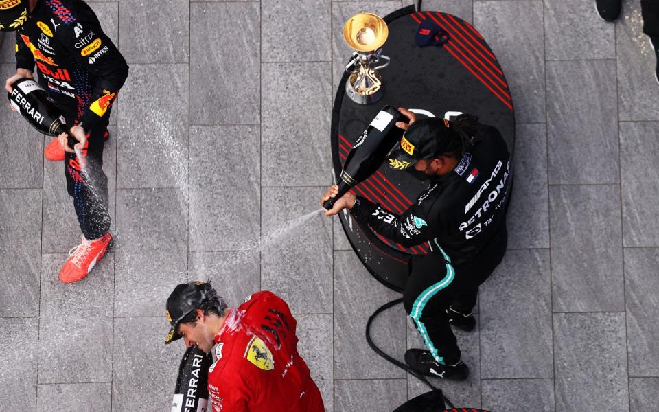 Race winner Lewis Hamilton of Great Britain and Mercedes GP, second placed Max Verstappen of Netherlands and Red Bull Racing and third placed Carlos Sainz of Spain and Ferrari celebrate on the podium during the F1 Grand Prix of Russia at Sochi Autodrom on September 26, 2021 in Sochi, Russia - Lars Baron - Formula 1/Formula 1 via Getty Images