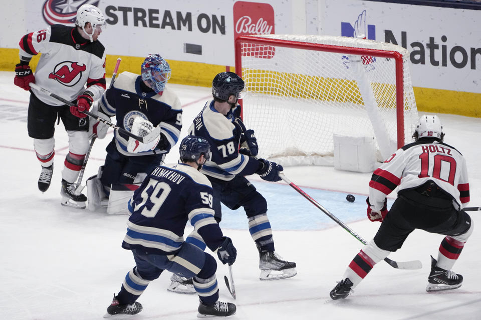 New Jersey Devils right wing Alexander Holtz (10) scores on Columbus Blue Jackets goaltender Elvis Merzlikins, as right wing Yegor Chinakhov (59) and defenseman Damon Severson (78) watch during the second period of an NHL hockey game Friday, Jan. 19, 2024, in Columbus, Ohio. (AP Photo/Sue Ogrocki)