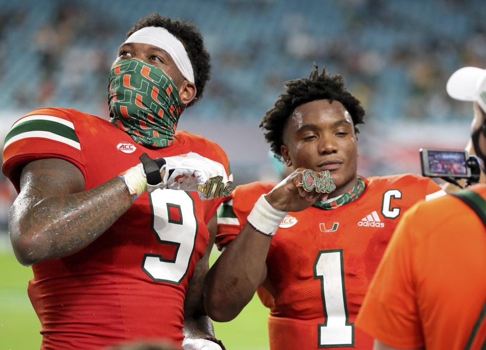 Miami tight end Brevin Jordan (9) and quarterback D'Eriq King (1) display their touchdown rings in the third quarter during an NCAA college football game against UAB in Miami Gardens, Fla., Thursday, Sept. 10, 2020. (Al Diaz/Miami Herald via AP)