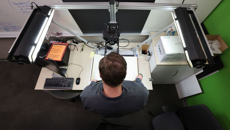 John Alexander, a senior product manager, digitizes historic property records at the FamilySearch headquarters in Lehi on Thursday, March 16, 2023.