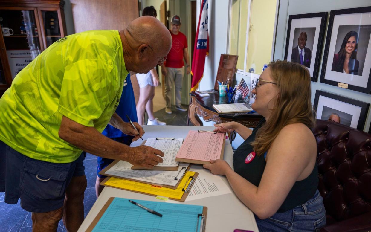 Jeff Hall comes in to sign the document to put the amendment on the ballot