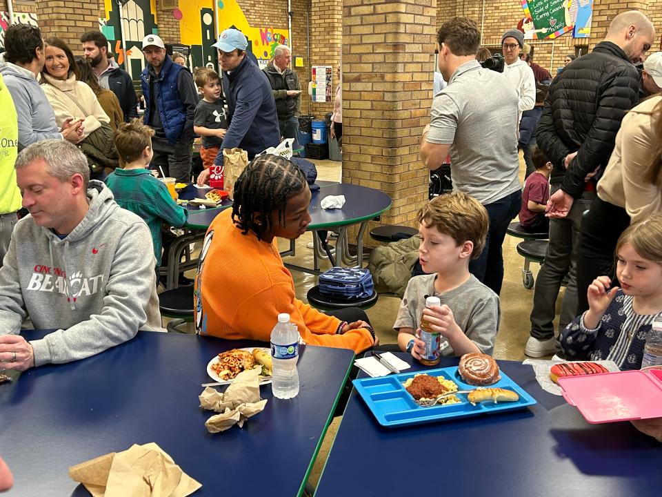 Xavier guard Quincy Olivari was the special guest of 6-year-old George Heller for lunch at St. Mary School in Hyde Park on Tuesday.