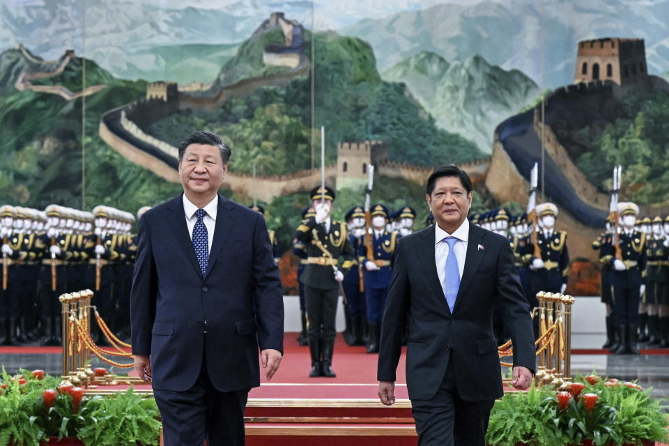 In this photo released by Xinhua News Agency, Visiting Philippine President Ferdinand Marcos Jr., right, walks with Chinese President Xi Jinping after reviewing an honor guard during a welcome ceremony at the Great Hall of the People in Beijing, Wednesday, Jan. 4, 2023. Philippine President Ferdinand Marcos Jr. is pushing for closer economic ties on a visit to China that seeks to sidestep territorial disputes in the South China Sea. (Shen Hong/Xinhua via AP)