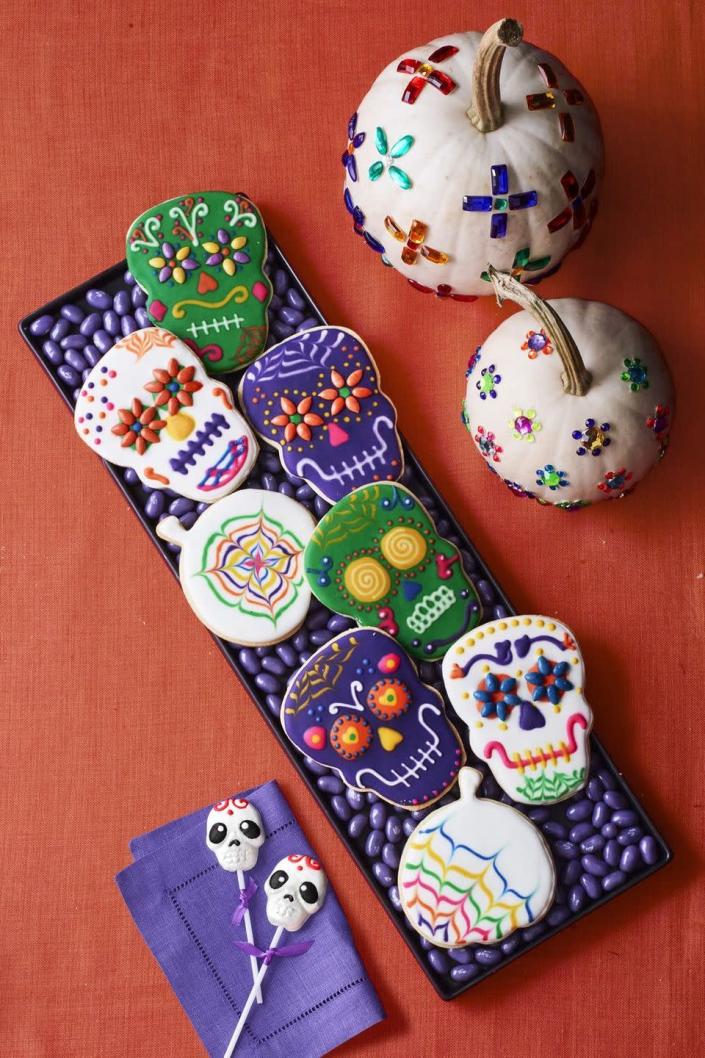 <p>Don't be intimidated by the intricate designs on these cookies — the recipe tells you simple ways to channel your inner artist.</p><p><strong><em><a href="https://www.womansday.com/food-recipes/food-drinks/a23569445/cookie-skulls-and-pumpkin-sugar-cookie-cutouts-recipe/" rel="nofollow noopener" target="_blank" data-ylk="slk:Get the Cookie Skulls recipe." class="link ">Get the Cookie Skulls recipe. </a></em></strong></p>