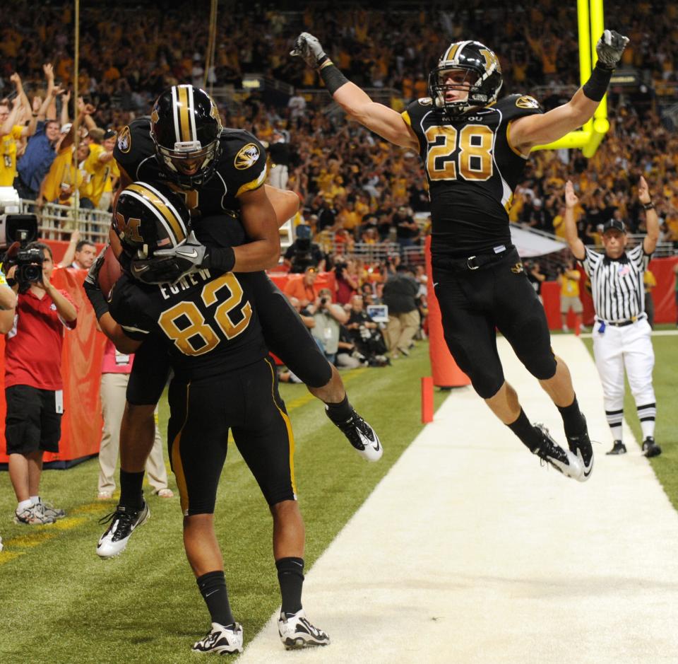 Missouri's Wes Kemp, top left, and T.J. Moe help Michael Egnew (82) celebrate after Egnew scored a touchdown during the fourth quarter of an NCAA college football game against Illinois, Saturday, Sept. 4, 2010, in St. Louis. Missouri won the game 23-13.