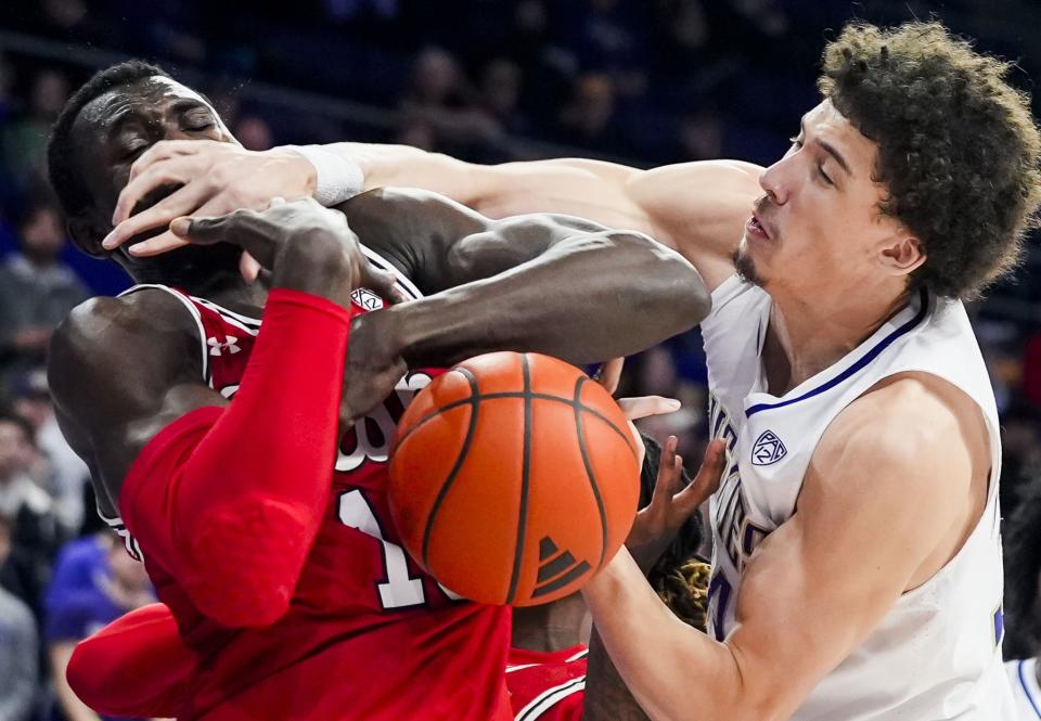 Washington center Braxton Meah, right, hits Utah center Keba Keita as they vied for a rebound during the first half of an NCAA college basketball game Saturday, Jan. 27, 2024, in Seattle. | Lindsey Wasson, Associated Press