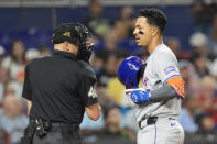 New York Mets' Mark Vientos, right, argues with home plate umpire Andy Fletcher after Vents struck out looking during the fourth inning of a baseball game against the Miami Marlins, Friday, May 17, 2024, in Miami. (AP Photo/Wilfredo Lee)
