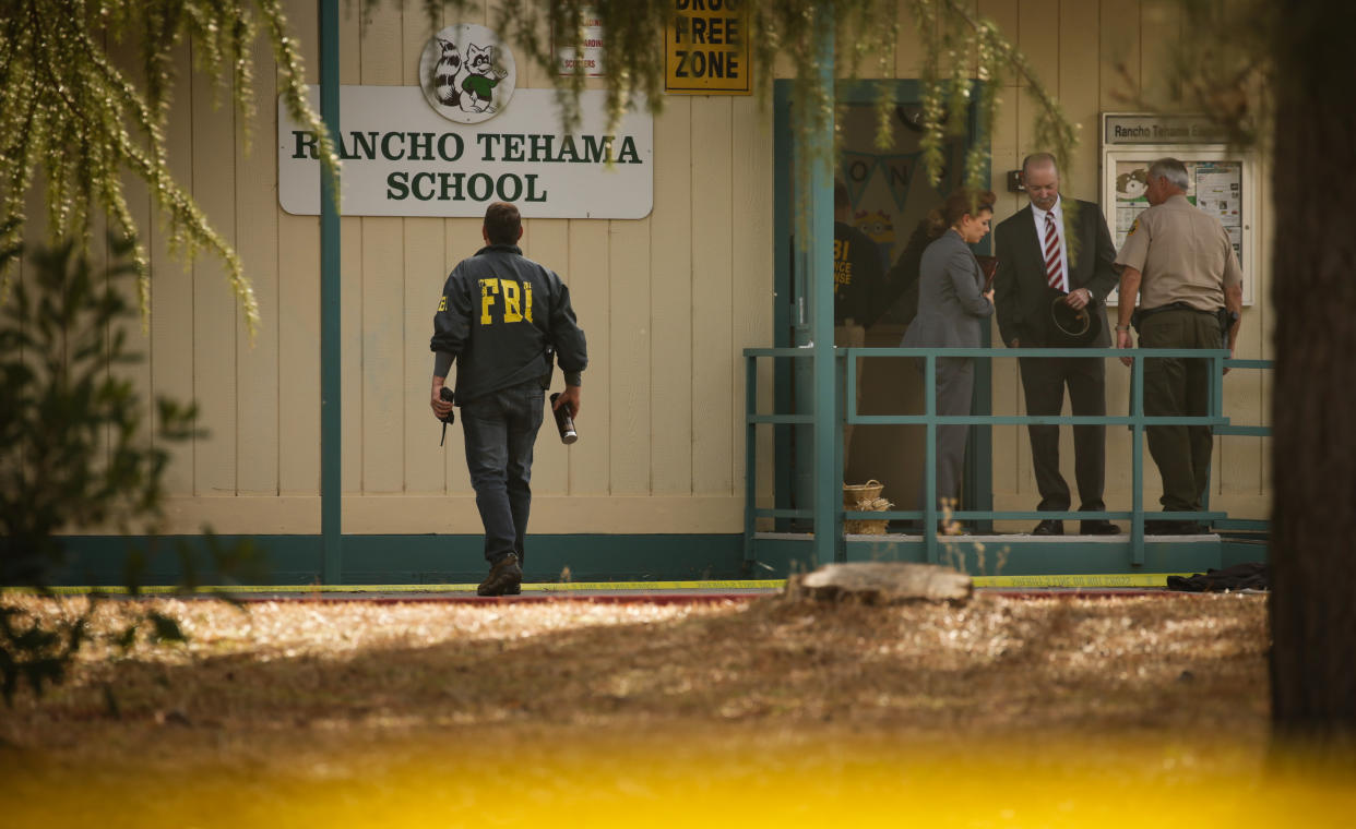 FBI agents are seen behind yellow crime scene tape outside Rancho Tehama Elementary School after a shooting in the morning on Nov. 14, 2017, in Rancho Tehama, Calif. (Photo: Elijah Nouvelage/AFP/Getty Images)