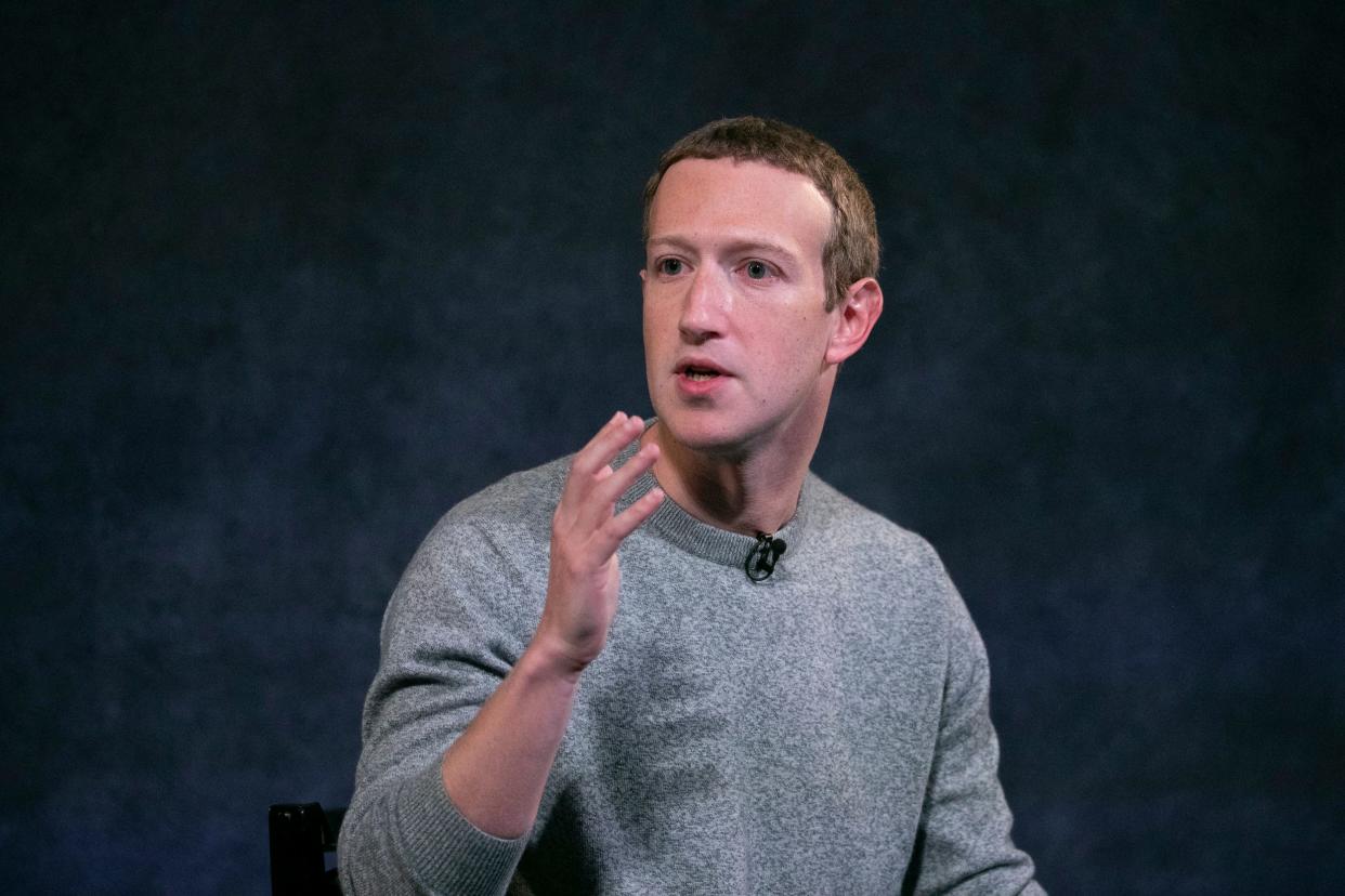 Mark Zuckerberg gestures with hand while speaking onstage