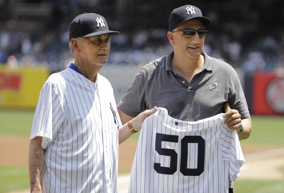 Astronaut Mike Massamino, right, poses for photographs with former New York Yankees pitcher Jack Aker before a baseball game between the New York Yankees and the Colorado Rockies Saturday, Jan. 20, 2019, in New York. (AP Photo/Frank Franklin II)
