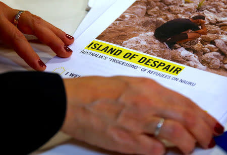 Anna Neistat, Senior Director for Research with Amnesty International, talks to journalists as she holds a copy of a report she co-authored titled 'Island of Despair - Australia's "Processing" of Refugees on Nauru' in Sydney, Australia, October 17, 2016 that concludes many of the 410 asylum seekers held on the tiny Pacific Island are being driven to attempt suicide to escape the prison-like conditions they face in indefinite detention on behalf of Australia. REUTERS/David Gray