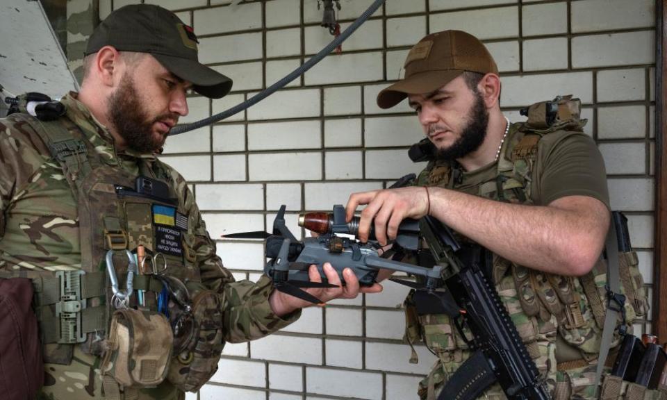 Ukrainian troops attach a bomb to a drone in the suburbs of Donetsk.