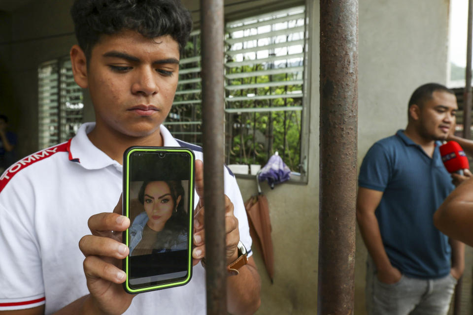 Jaser Daniel Ortiz shows a photo of his mother Nayarith Bueso in El Progreso, Honduras, Thursday, June 30, 2022. Nayarith Bueso was among the more than 50 migrants who were found dead inside a tractor-trailer near San Antonio, Texas. (AP Photo/Delmer Martinez)