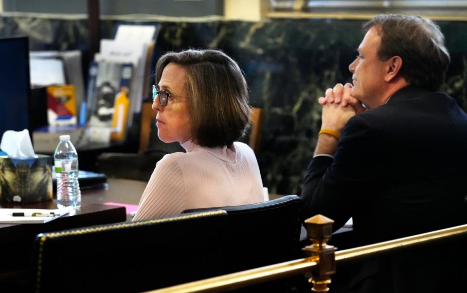 Katherine Snyder, and her husband, John Snyder, sit at the defense table awaiting opening statements in their trial on Friday, Oct. 13, 2023. They are charged with aggravated murder in the death of their adopted son, Adam, 8, in 2016. The Snyders adopted five children from China, including Adam, all with special needs. They have three biological children.