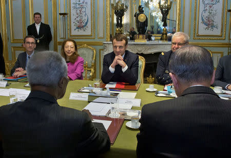 Members of the Elder group, former Secretary-Generals of the United Nations Kofi Annan (L) and Ban Ki-moon (R) sit across from France's President Emmanuel Macron at the Elysee Palace in Paris, France, December 11, 2017. REUTERS/Michel Euler/Pool