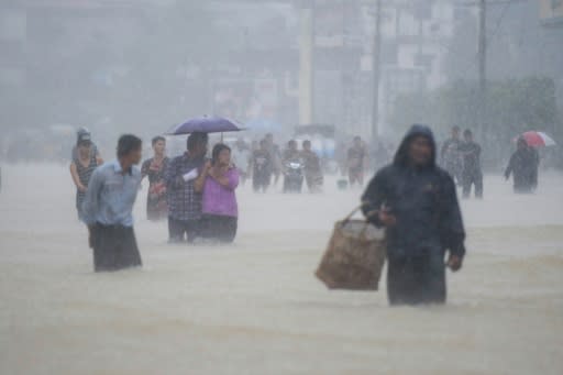 Residents walk in floodwaters in the Bago region