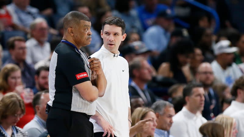 Oklahoma City Thunder coach Mark Daigneault, right, talks to official Tony Brothers, left, during the second half of an NBA basketball game against the Milwaukee Bucks, Friday, April 12, 2024, in Oklahoma City.