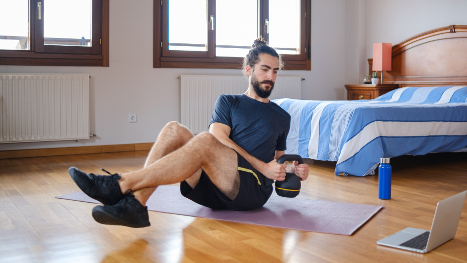 Man doing kettlebell Russian twist exercise