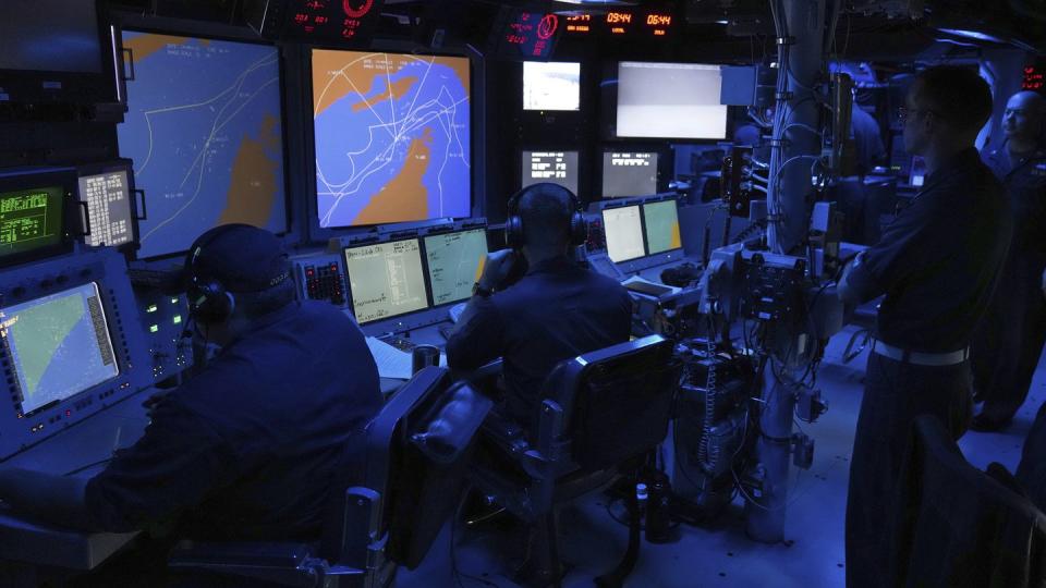 U.S. Navy sailors work in the Combat Information Center of the guided-missile destroyer Paul Hamilton in the Strait of Hormuz Friday, May 19, 2023. (Jon Gambrell/AP)