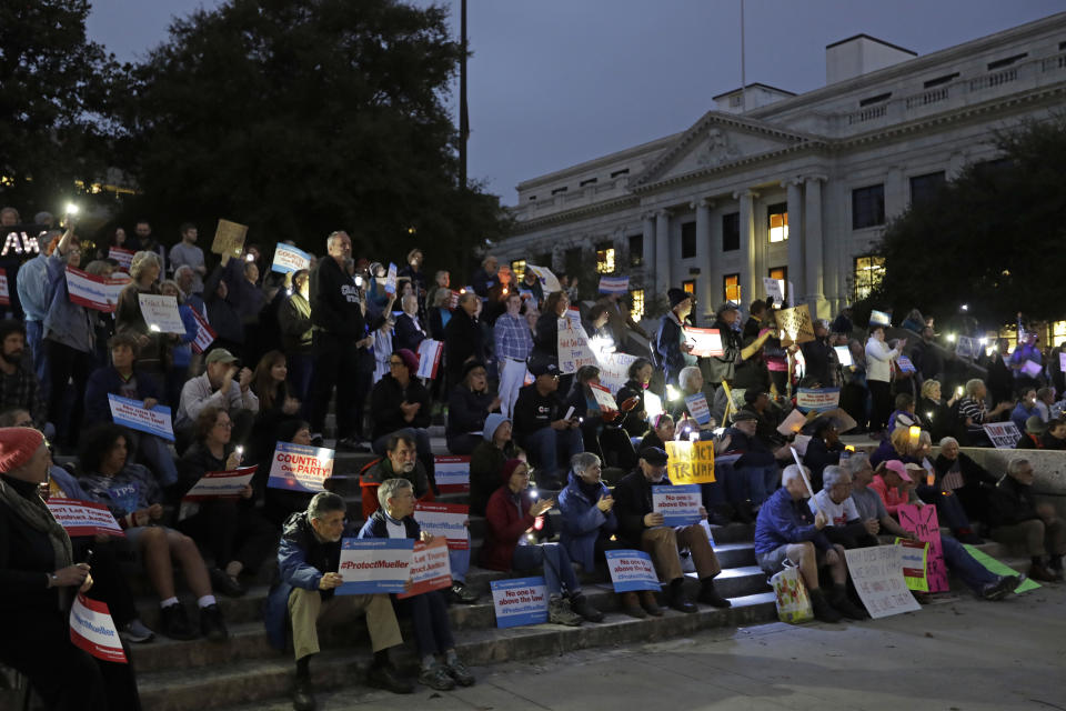 Protestors listen to a speaker during a rally outside the Guilford County Courthouse against President Trump's Attorney General move that could jeopardize the Special counsel's work in Greensboro, N.C., Thursday, Nov. 8, 2018. (AP Photo/Chuck Burton)