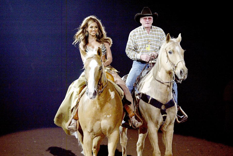 Singer Beyonce Knowles arrives on horseback to perform for her hometown crowd at the Houston Livestock Show and Rodeo, March 18, 2004, in Houston, Texas.