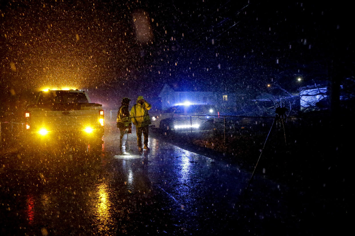 Emergency personnel survey a damaged mobile home after a possible tornado passed through Thursday, Feb. 17, 2022, in Leeds, Ala. (AP Photo/Butch Dill)