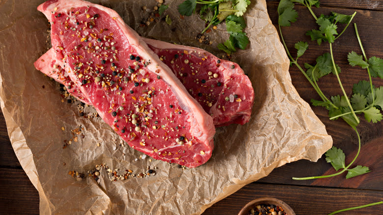 Seasoned raw New York strips 