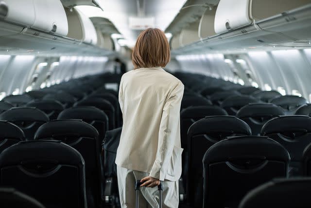 <p>Â©2022 Susumu Yoshioka/Getty</p> Businesswoman traveling on an airplane to a business destination