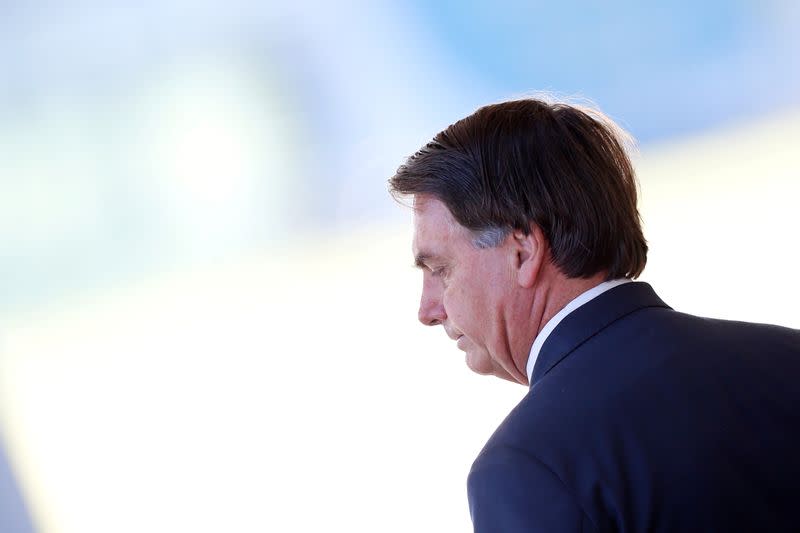 FILE PHOTO: Brazil's President Jair Bolsonaro looks on as he leaves the Alvorada Palace, amid coronavirus disease (COVID-19) outbreak, in Brasilia