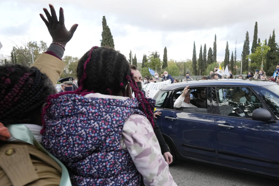 Pope Francis arrives for a meeting with young people at the Saint Dionysius School of the Ursuline Sisters in Athens, Greece, Monday, Dec. 6, 2021. Francis' five-day trip to Cyprus and Greece has been dominated by the migrant issue and Francis' call for European countries to stop building walls, stoking fears and shutting out "those in greater need who knock at our door." (AP Photo/Alessandra Tarantino)