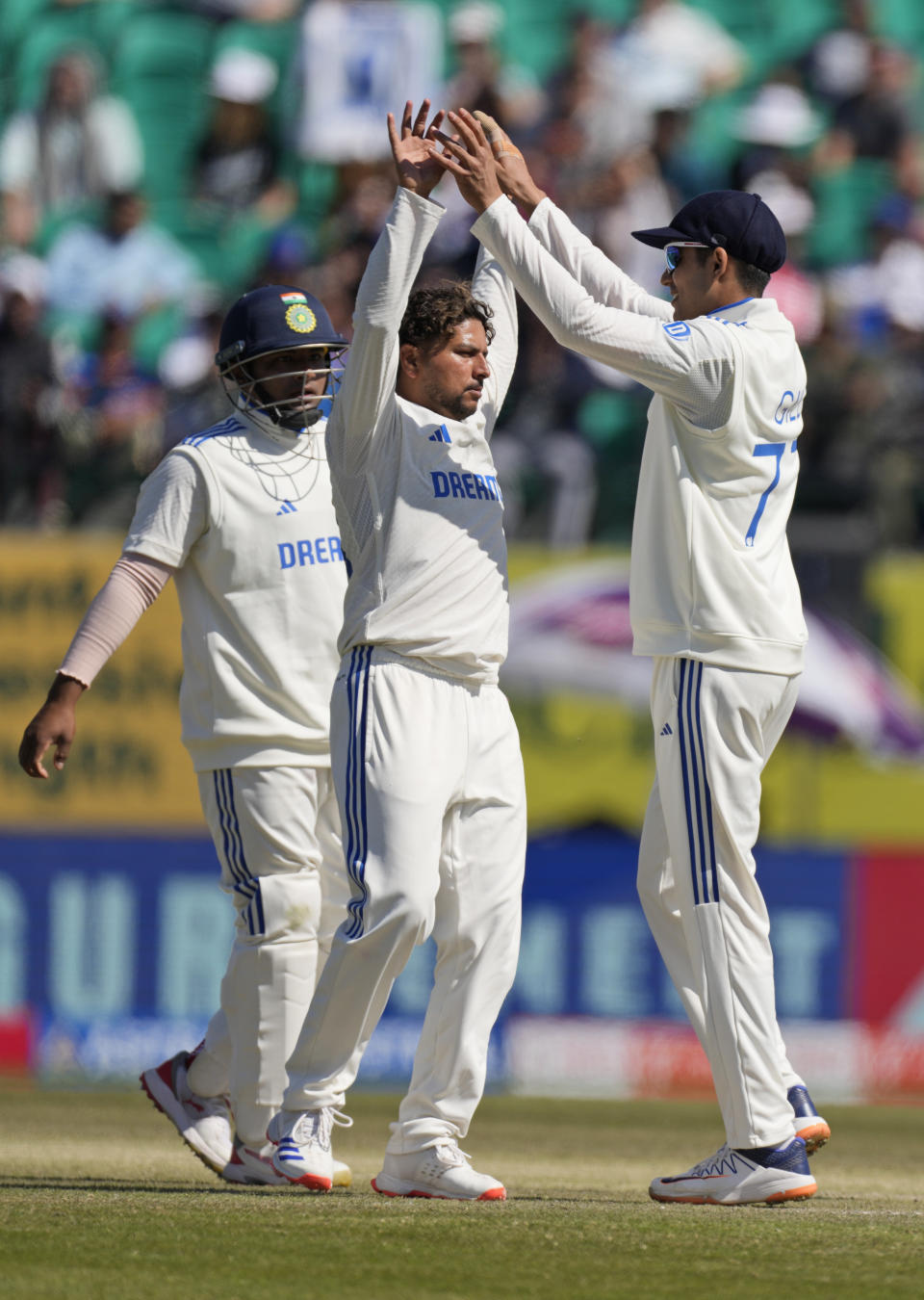 India's Kuldeep Yadav, centre, celebrates the wicket of England's Jonny Bairstow on the third day of the fifth and final test match between England and India in Dharamshala, India, Saturday, March 9, 2024. (AP Photo /Ashwini Bhatia)