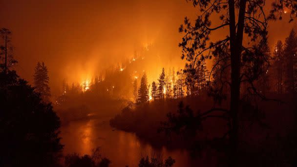 PHOTO: Flames burn to the Klamath River during the McKinney Fire in the Klamath National Forest northwest of Yreka, Calif., July 31, 2022.  (David Mcnew/AFP via Getty Images)