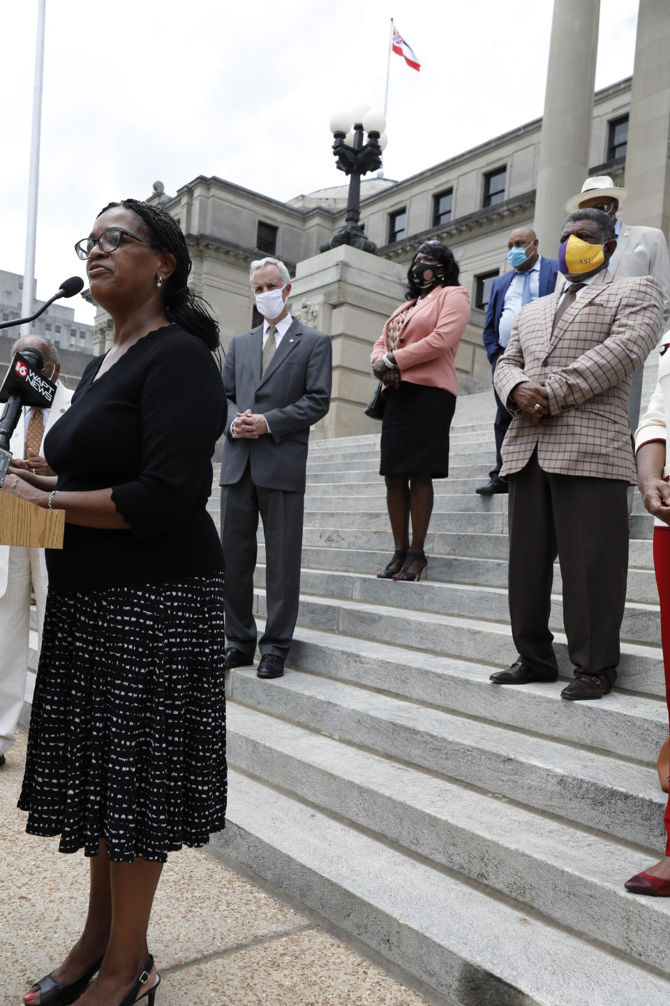Sen. Angela Turner Ford, D-West Point, chairwoman of the Mississippi Legislative Black Caucus, left, expresses the group's approval of the passage by the Legislature of legislation to take down and replace the current state flag which contains the Confederate battle emblem, during a news conference at the Capitol in Jackson, Miss., Monday, June 29, 2020. (AP Photo/Rogelio V. Solis)