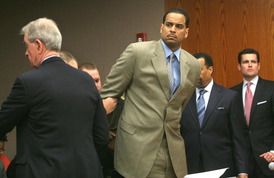 FILE - Jayson Williams is handcuffed after he was sentenced to five years in prison Tuesday Feb. 23, 2010, at State Superior Court , in Somerville, N.J., for fatally shooting a hired driver in 2002. The teenage daughters of former NBA All-Star Jayson Williams have denounced St. John’s University for its decision to induct their father into the school’s Athletics Hall of Fame. Tryumph and Whizdom Williams both wrote open letters they sent Friday, Oct. 21, 2022, to The Associated Press, and also planned to send to St. John’s, that said the school should be ashamed for his induction into the class during Saturday’s homecoming weekend. (AP Photo/Kathy Johnson, Pool, File)