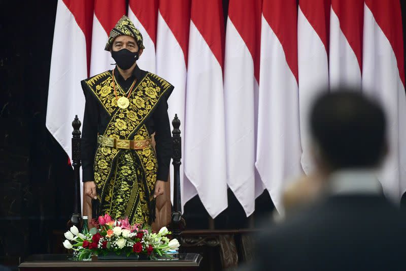 Indonesian President Joko Widodo dressed in a traditional Indonesian costume from Sabu, stands before delivering a speech ahead of the 75th Independence Day, at the parliament building in Jakarta