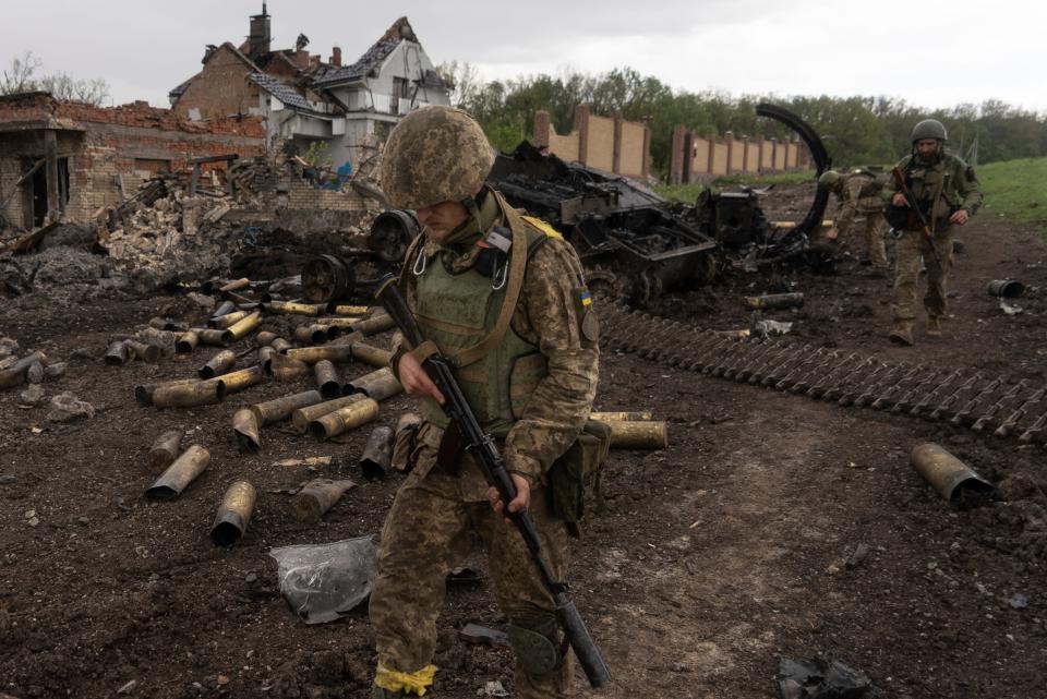 Ukrainian servicemen patrol in a recently retaken village, north of Kharkiv, east Ukraine, on Sunday.