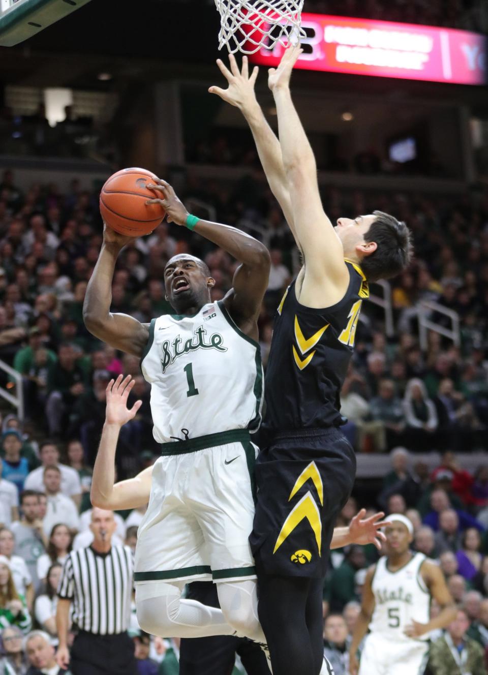 Michigan State guard Joshua Langford scores against Iowa guard Joe Wieskamp during first half action Monday, December 3, 2018 at the Breslin Center in East Lansing, Mich.