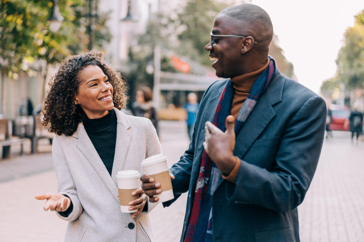 Shot of an affectionate young couple bonding together outdoors. Portrait of an adorable african-american young couple walking outdoor in the city.