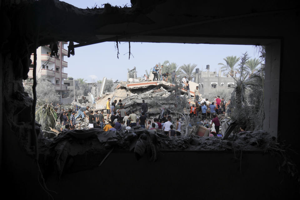 FILE - Palestinians look for survivors after the Israeli bombardment of the Gaza Strip in Deir Al-Balah on Oct. 22, 2023. U.N. humanitarian monitors say at least 2,700 people, including 1,500 children, are missing and believed buried under the rubble. (AP Photo/Hatem Moussa, File)