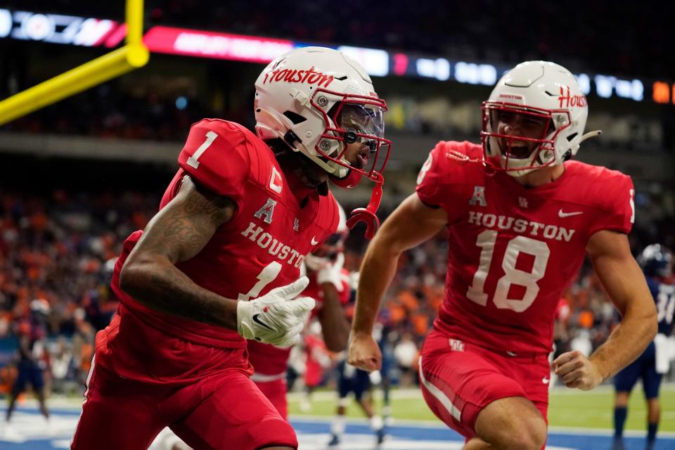 Houston wide receiver Nathaniel Dell (1) celebrates with teammate Joseph Manjack IV (18) after his touchdown catch during the second half of an NCAA college football game against UTSA, Saturday, Sept. 3, 2022, in San Antonio. (AP Photo/Eric Gay)