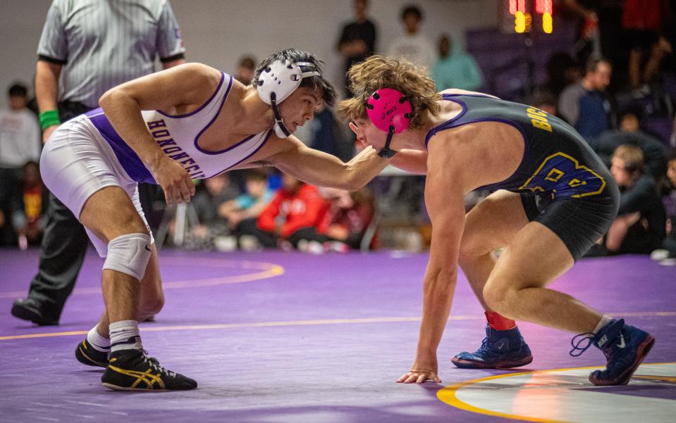 Hononegah's Thomas Silva, right, looks for an advantage to take down Belvidere co-op's Dominick Girardin during the 138-pound class of the NIC-10 Varsity Conference Wrestling Tournament on Saturday,Jan. 27, 2024, at Hononegah High School in Rockton. Silva won the title by a 19-3 technical fall.