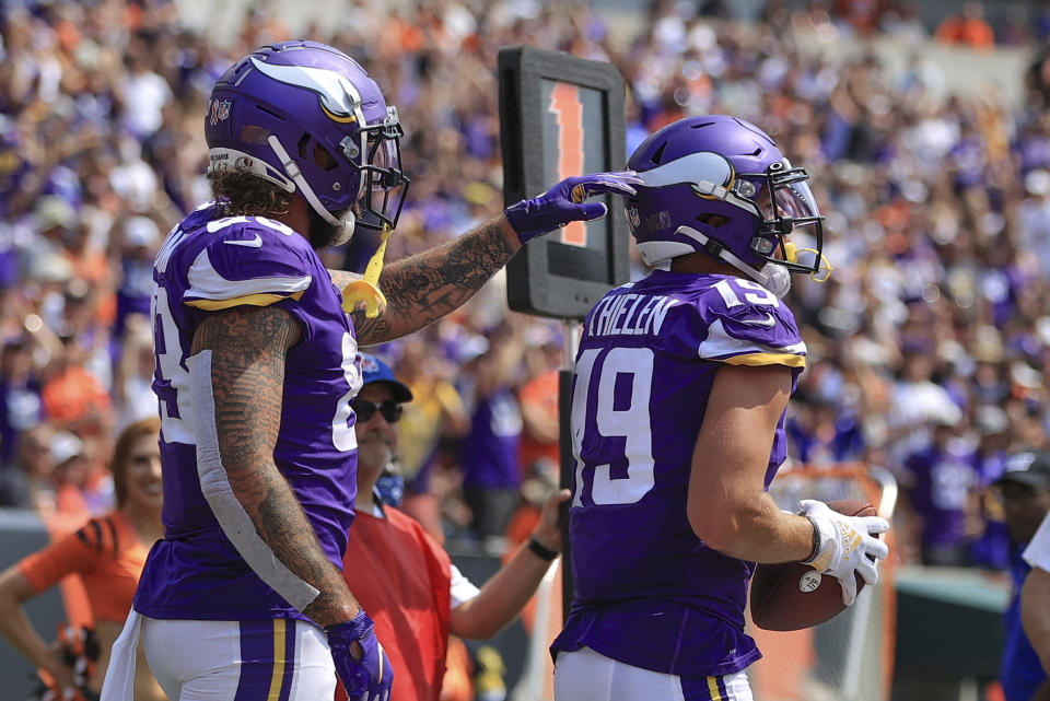 Minnesota Vikings wide receiver Adam Thielen (19) is greeted by tight end Tyler Conklin (83) after he made a catch for a touchdown against the Cincinnati Bengals in the first half of an NFL football game, Sunday, Sept. 12, 2021, in Cincinnati. (AP Photo/Aaron Doster)