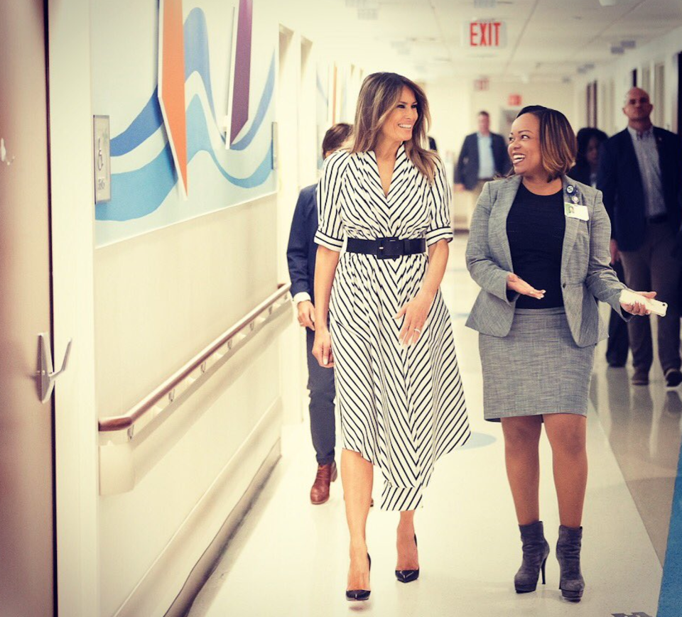 <p>While visiting a hospital, Melania rocked a $1,770 pleated striped dress by Adam Lippes. The designer had previously turned one of his fashion presentations into a statement in support of Planned Parenthood. (Photo: Twitter/Flotus) </p>