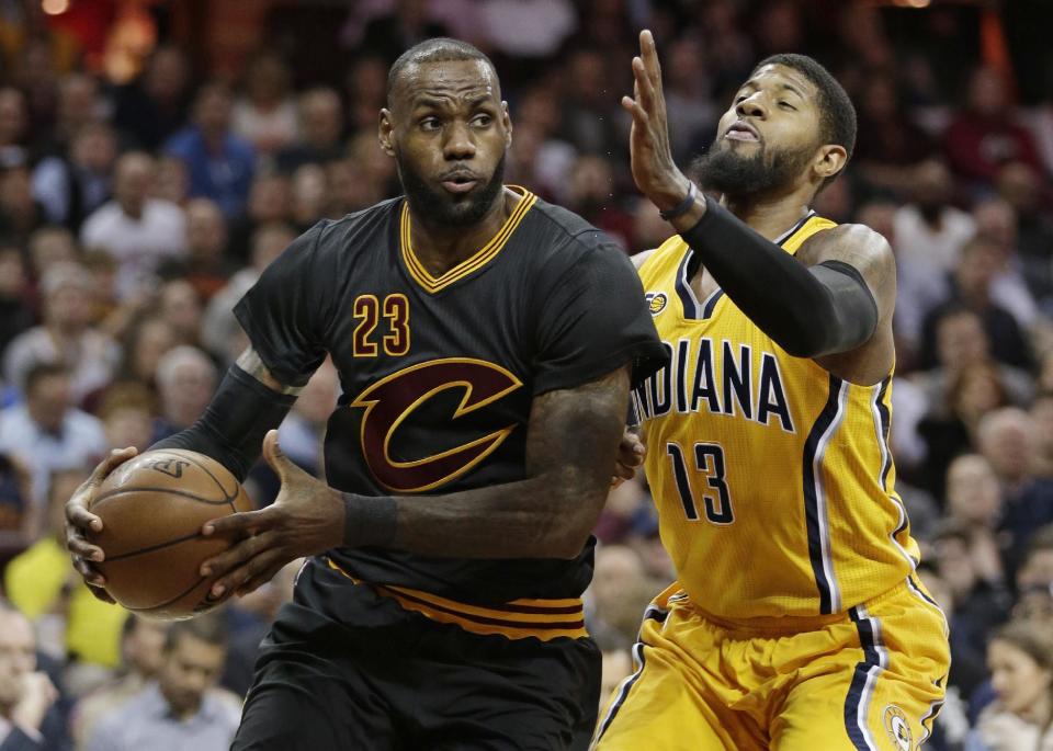 Cleveland Cavaliers' LeBron James (23) drives against Indiana Pacers' Paul George (13) in the first half of an NBA basketball game, Wednesday, Feb. 15, 2017, in Cleveland. (AP Photo/Tony Dejak)