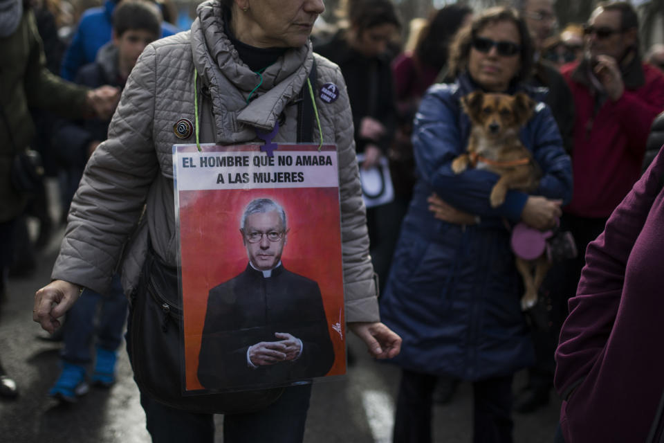 A protestor carries a banner reading "The man who doesn't love women" with a picture of Spain's Justice Minister Alberto Ruiz-Gallardon, as she marches towards the Spanish Parliament during a protest against government's plan to implement major restrictions on abortions, in Madrid, Spain, Saturday, Feb. 1, 2014. The rally was organized Saturday by dozens of women's groups that fight for reproductive rights.(AP Photo/Andres Kudacki)