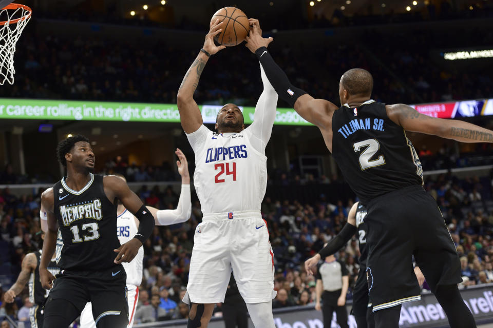 Los Angeles Clippers guard Norman Powell (24) handles the ball against Memphis Grizzlies forward Xavier Tillman (2) in the second half of an NBA basketball game Friday, March 31, 2023, in Memphis, Tenn. (AP Photo/Brandon Dill)